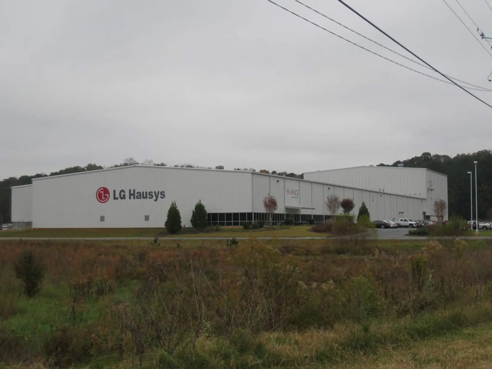 a large white building with a parking lot in front of it