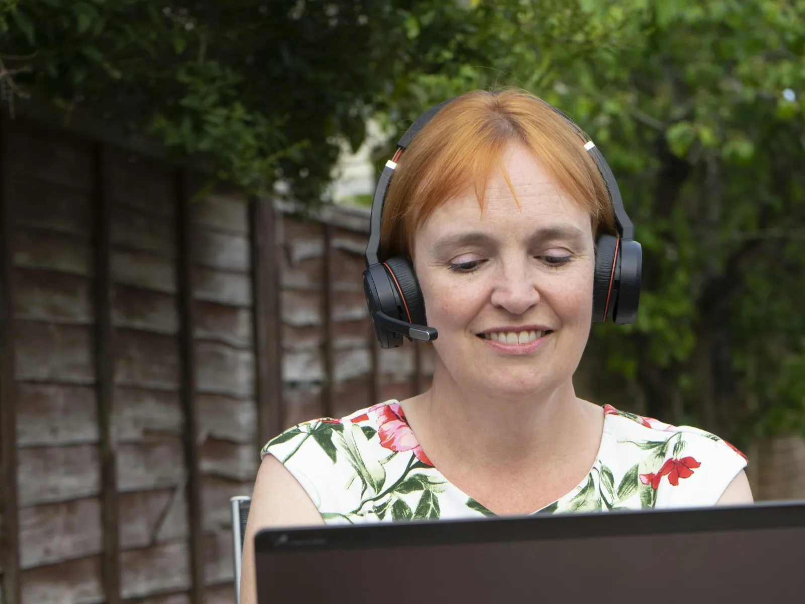 a person wearing headphones and using a laptop