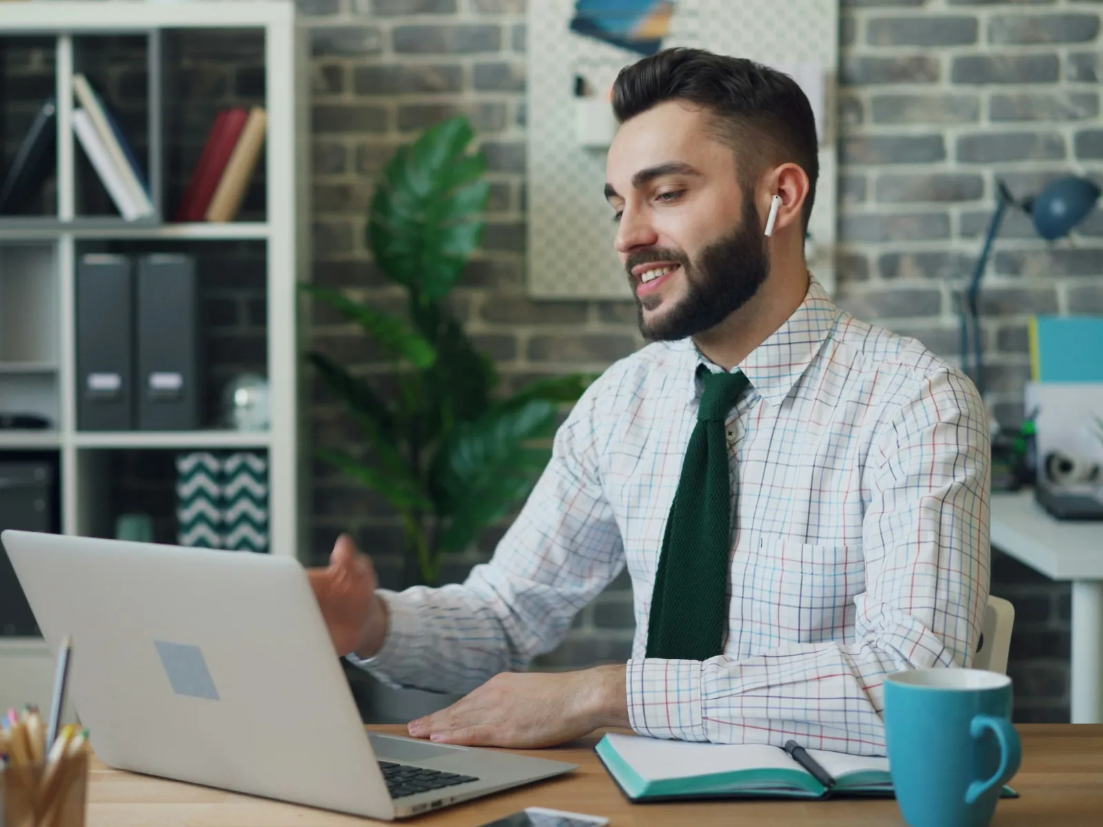 a man sitting at a table with a laptop