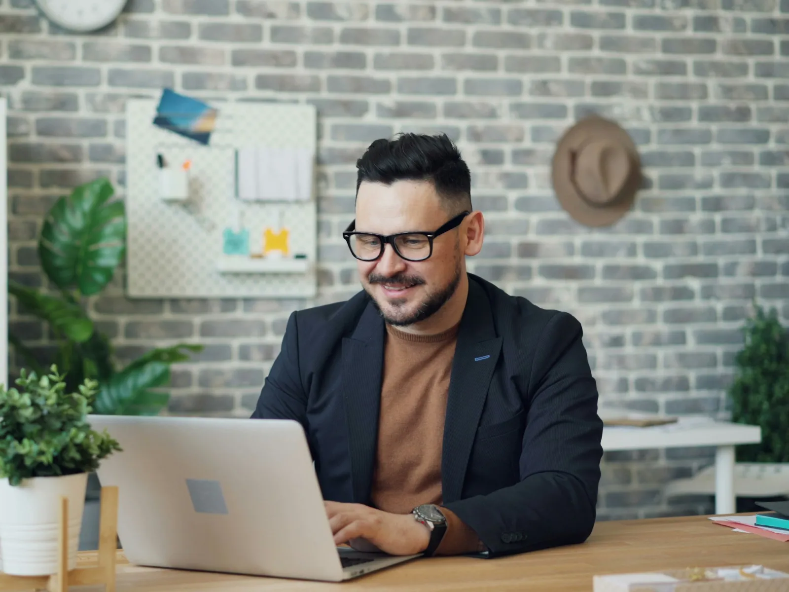 a man sitting at a table with a laptop