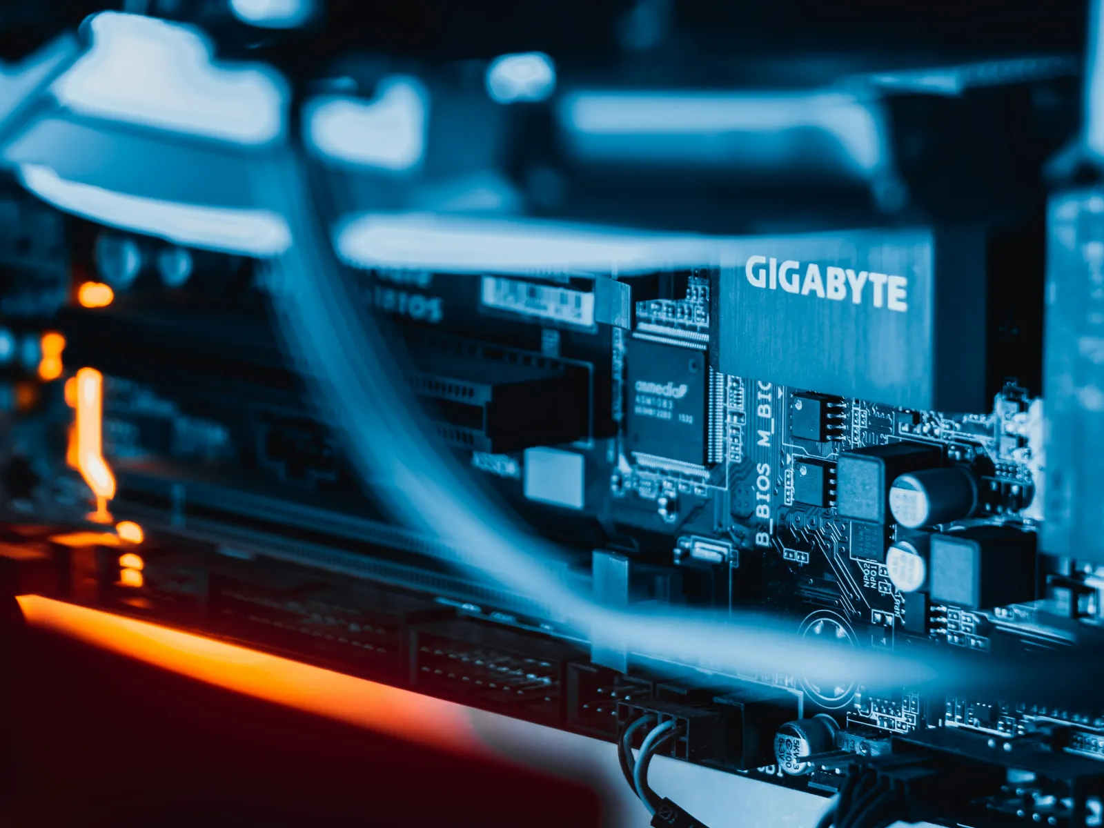 Close-up of a Gigabyte motherboard showcasing electronic components with vibrant lighting.