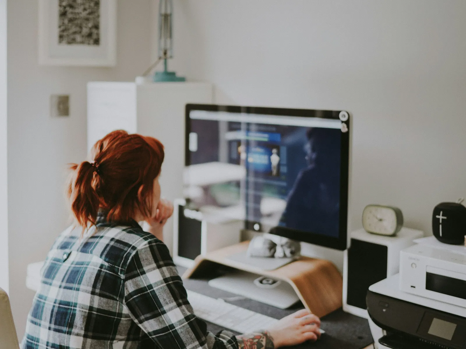 a person sitting at a desk with a computer