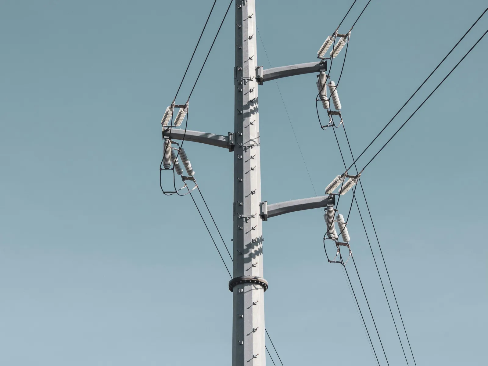 a tall white pole with wires