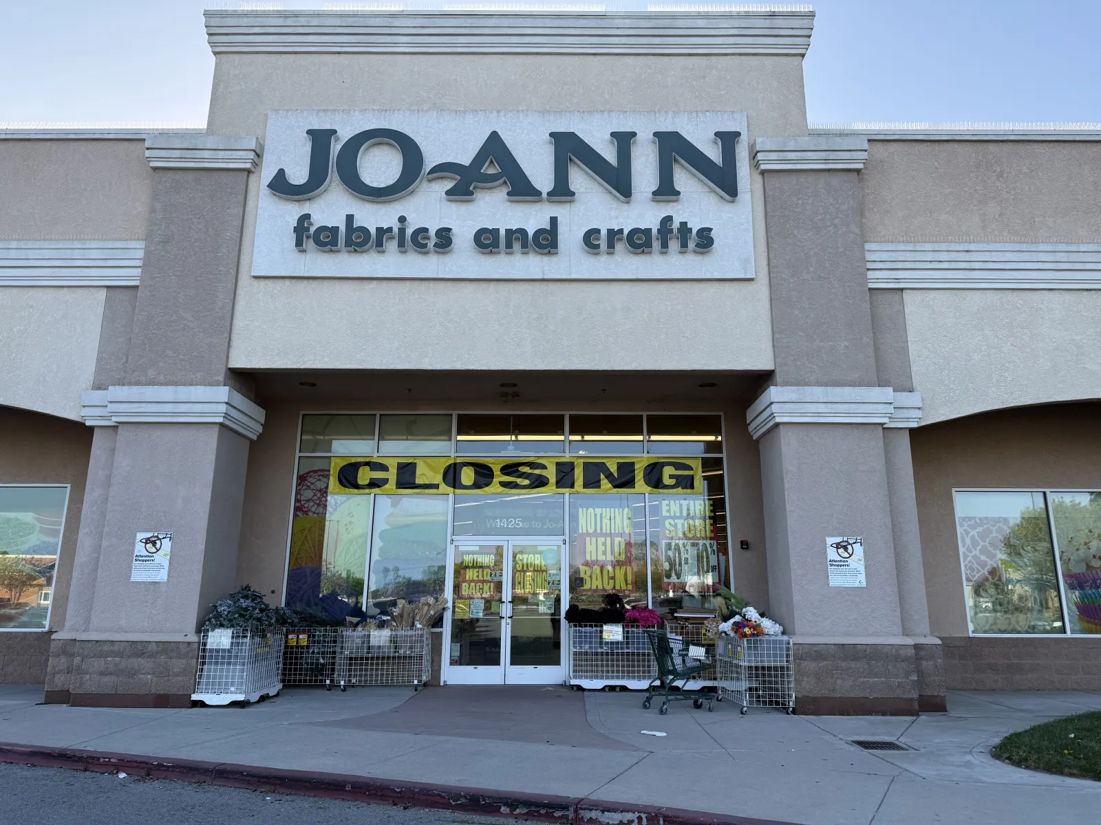 Jo-Ann Fabrics and Crafts store with closing sale signs and shopping carts outside the entrance