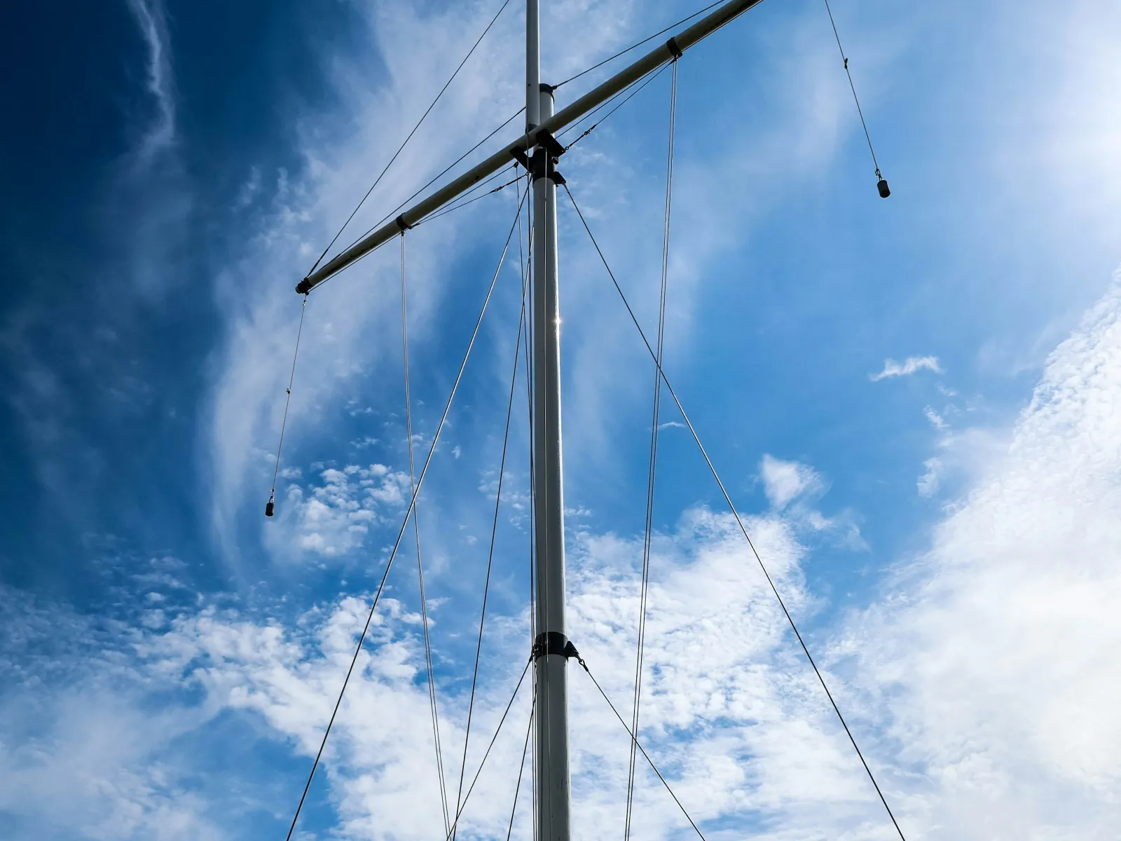 a tall white pole with wires