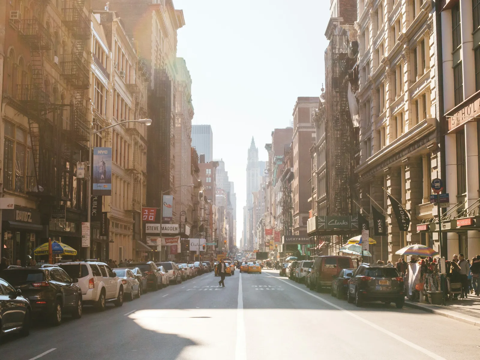 Rusty metal chain and padlock securing a metal gate with blurred background and warm light bokeh.