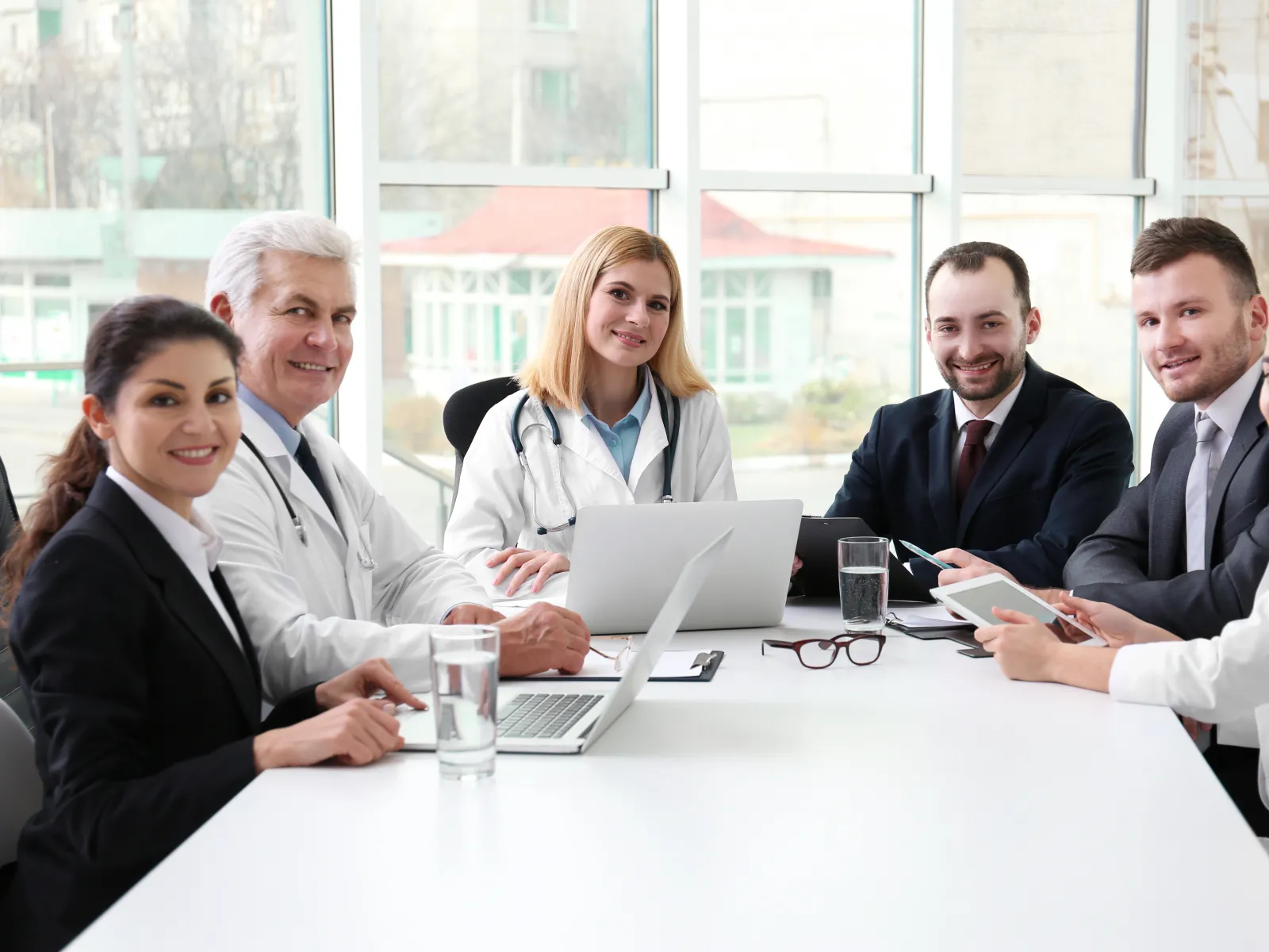 Medical professionals and colleagues collaborating in a bright conference room.