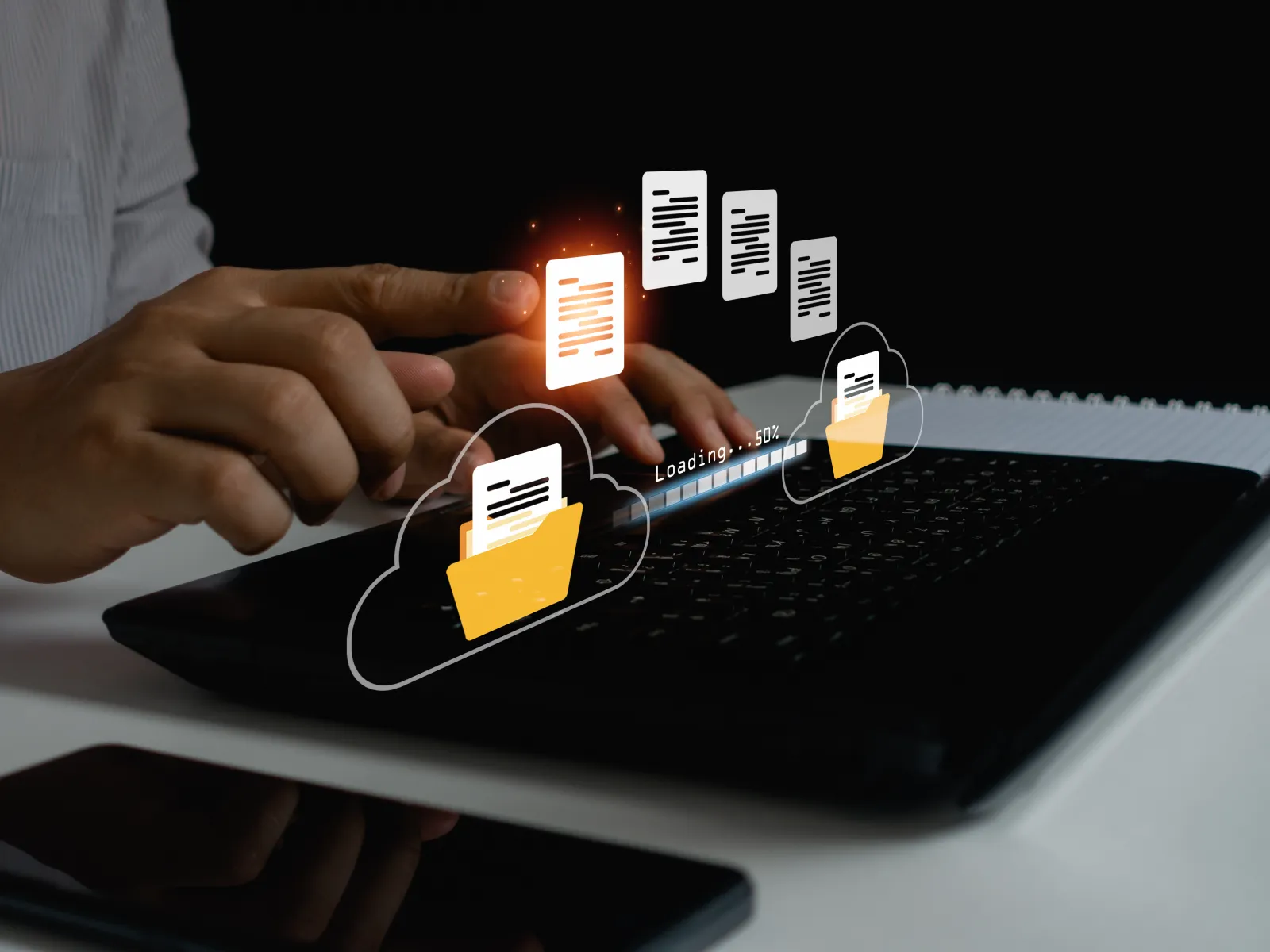 Person using laptop with file transfer graphics and clouds for digital data movement.