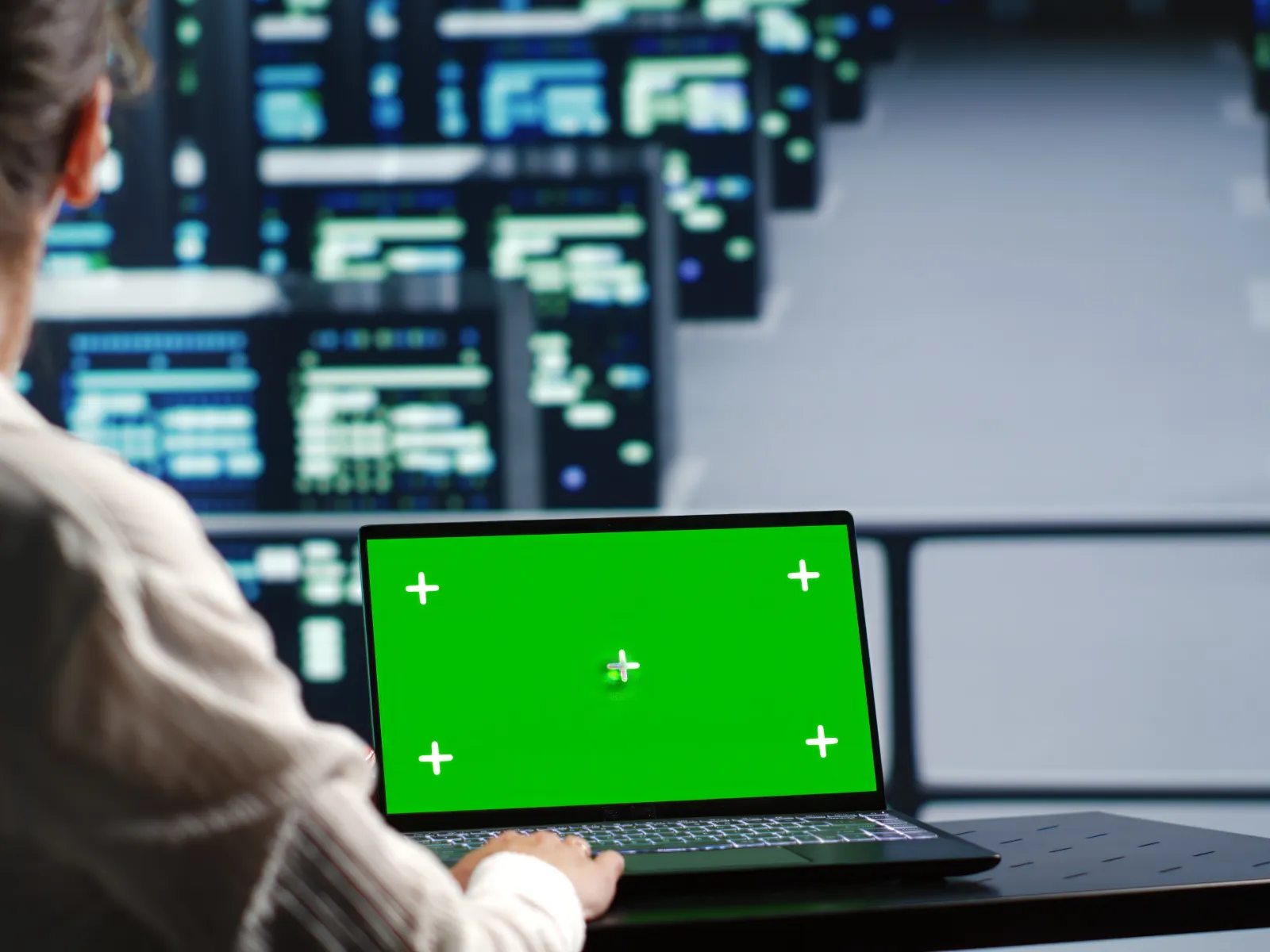 Professional man typing on a keyboard with a warning symbol displayed digitally.