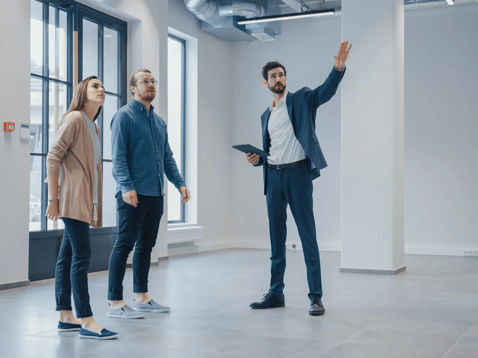 a few people standing in a hallway