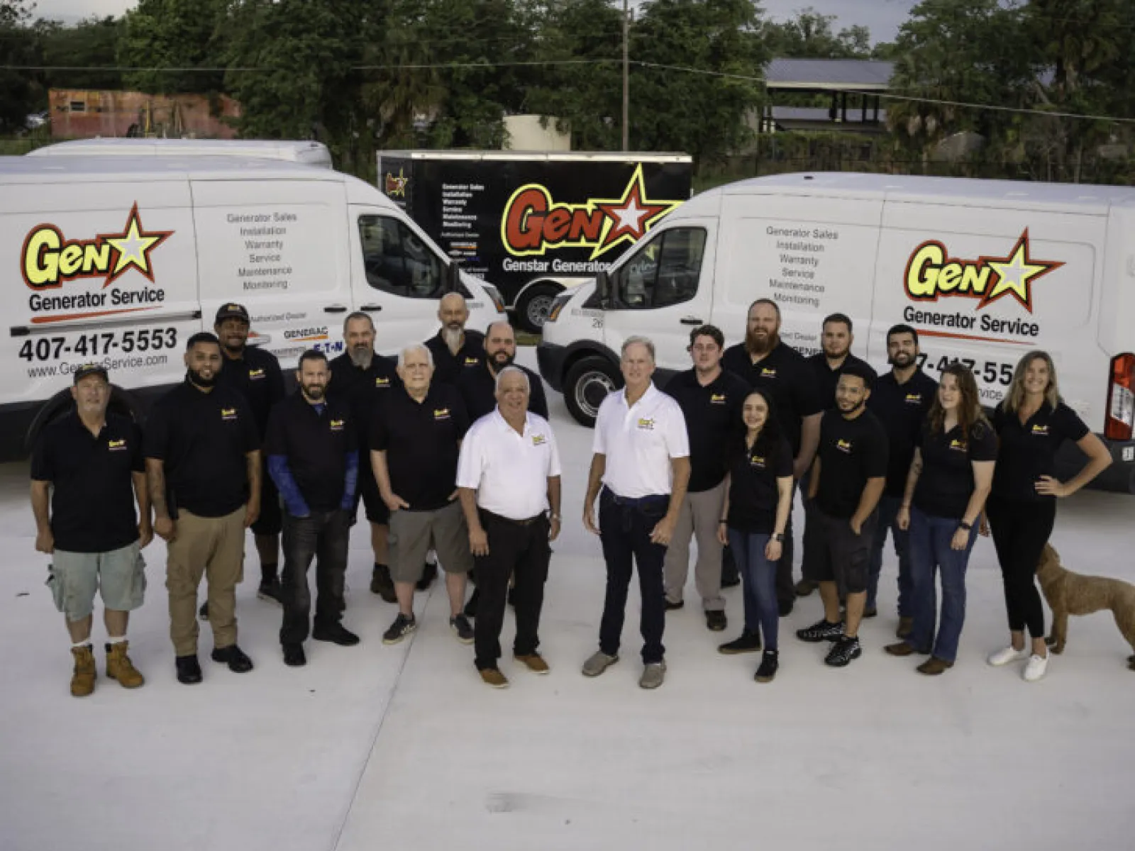 Group photo of GenX Generator Service team in front of branded service vans.