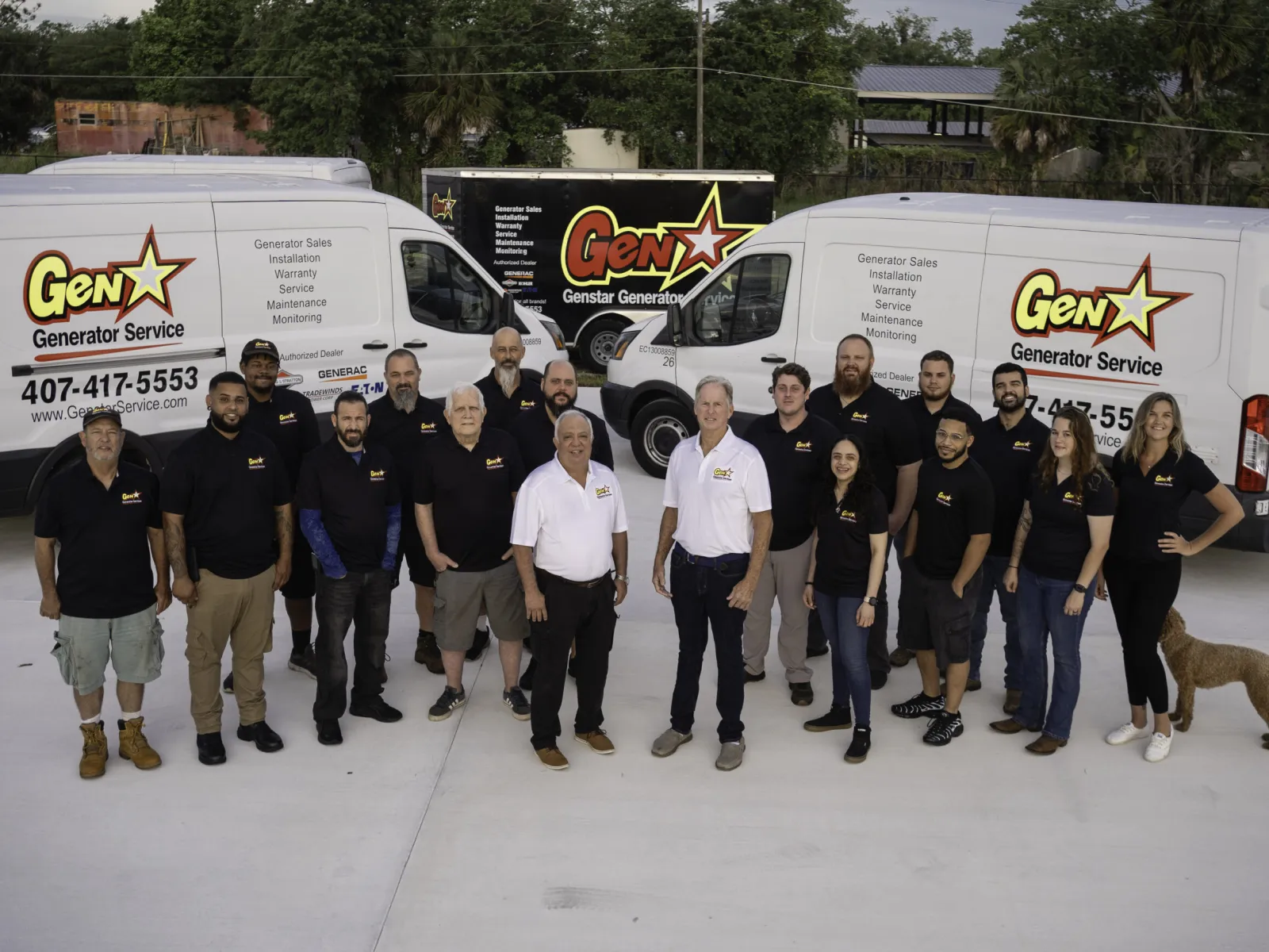 Group photo of GenX Generator Service team in front of service vans, showcasing a friendly and professional atmosphere.