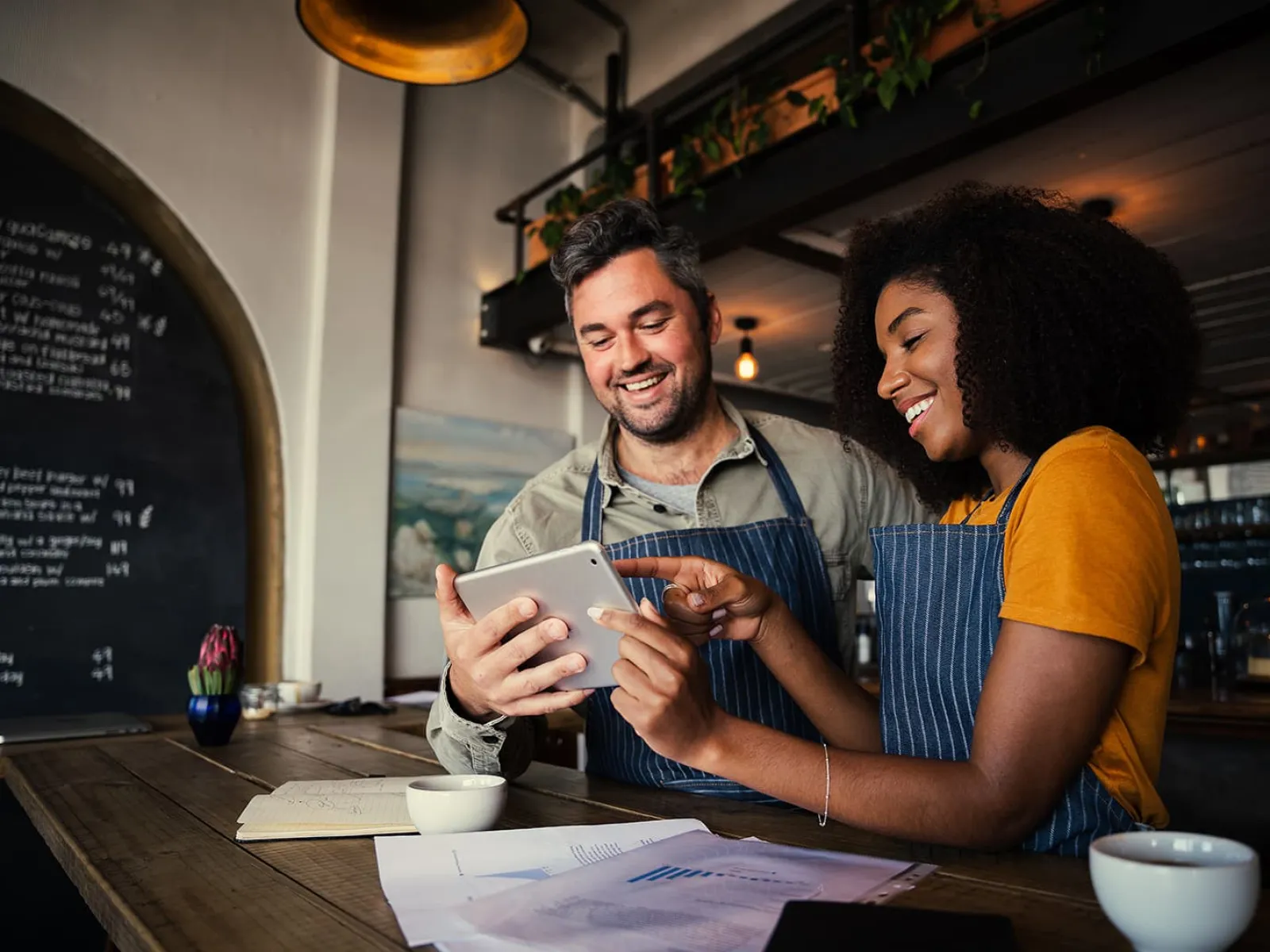 a man and a woman looking at a paper