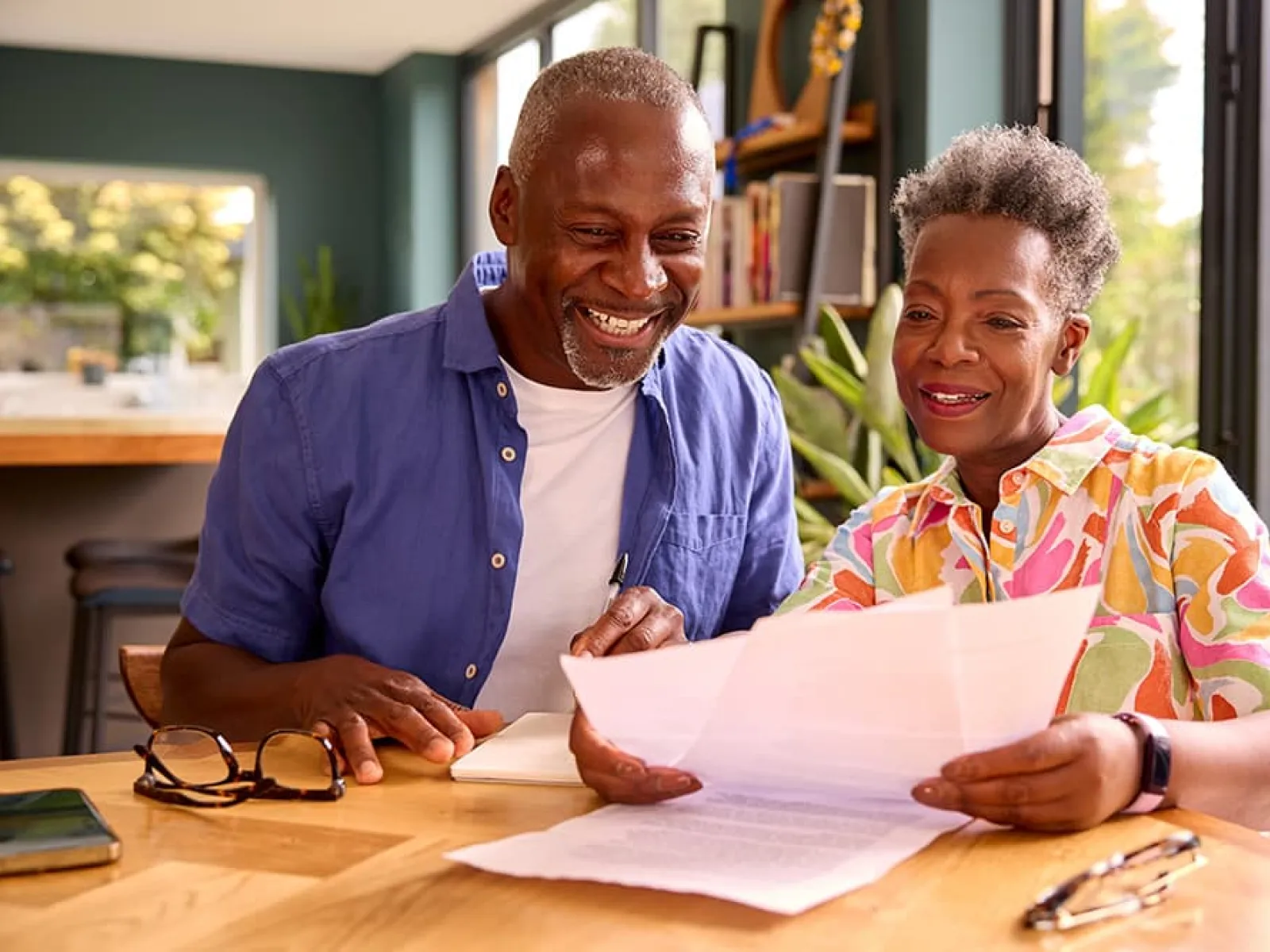 a man and a woman looking at a paper