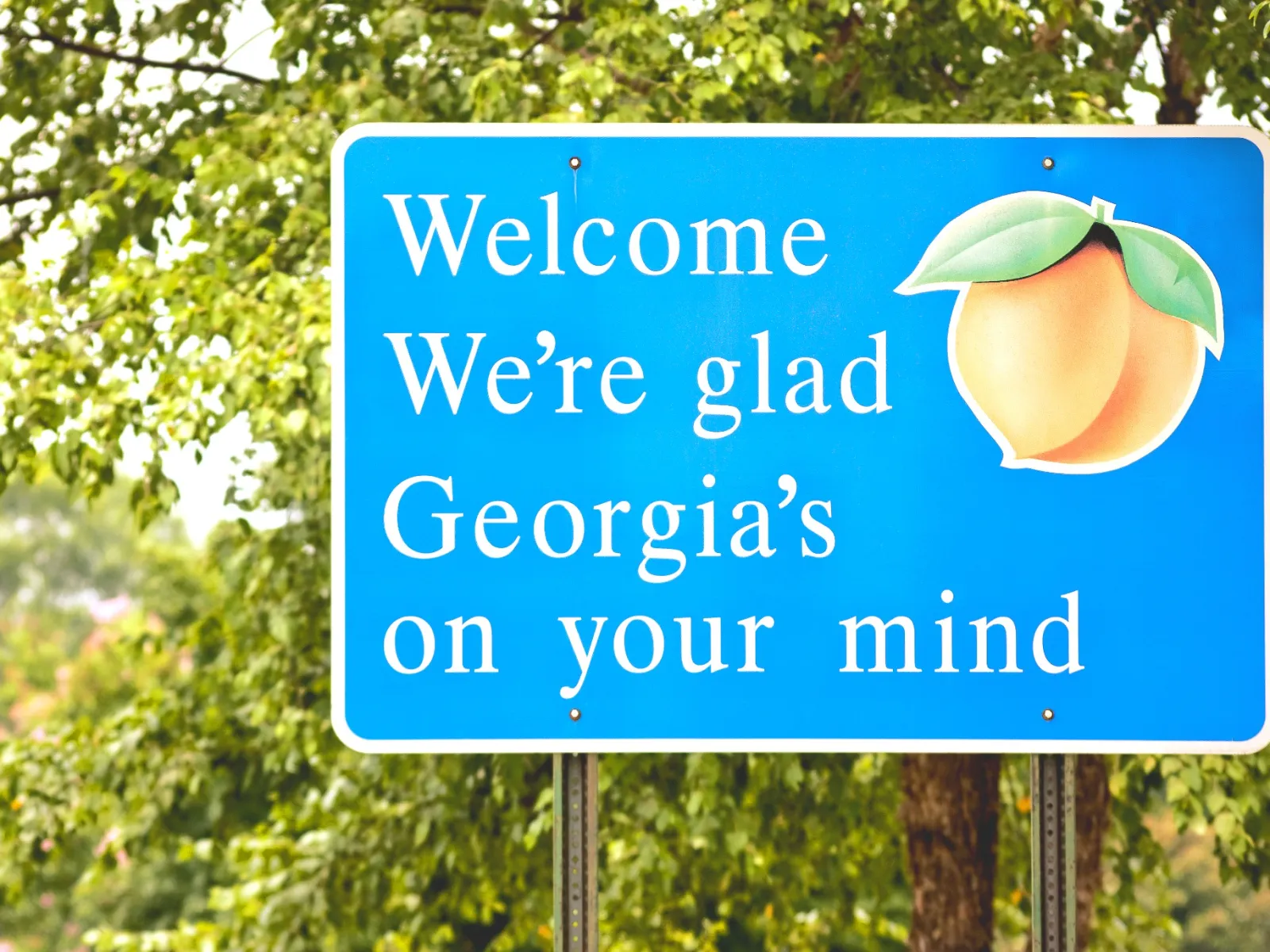 a blue sign with a green apple on it