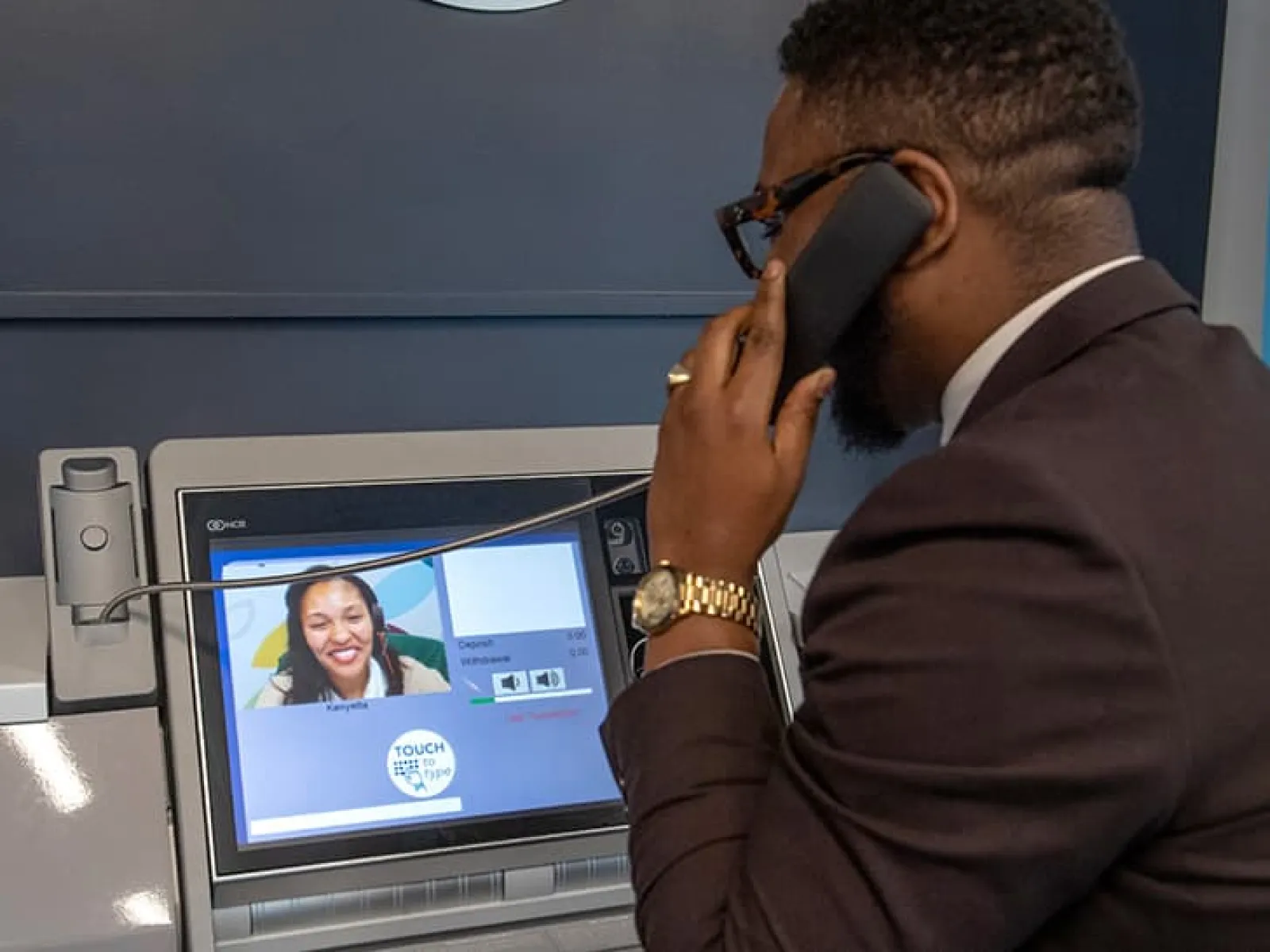 a man wearing headphones and looking at a screen