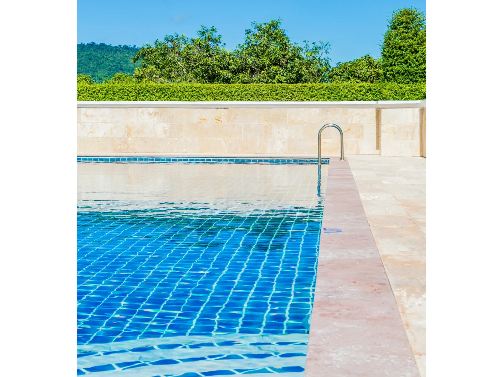 a swimming pool with a blue and white tile floor