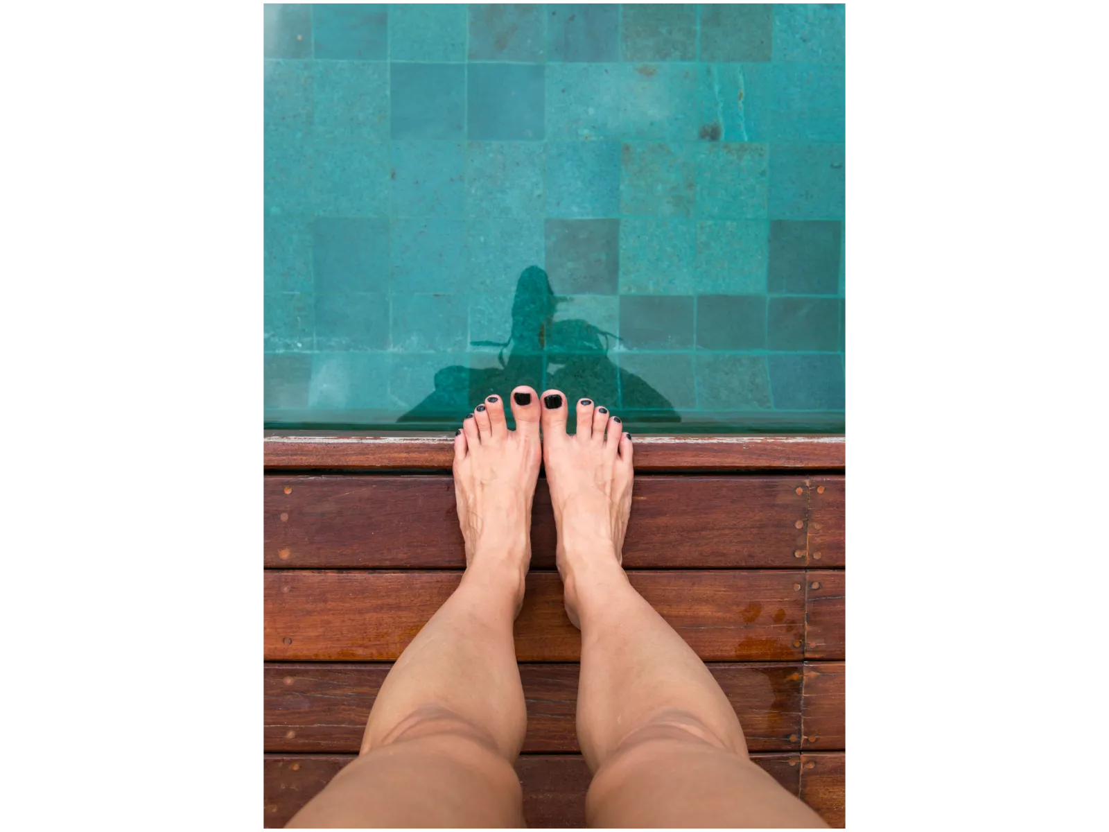 a person's feet on a wooden surface