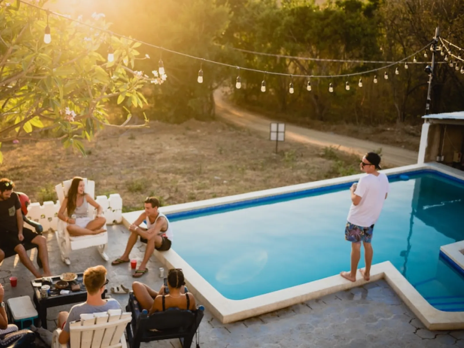 a group of people sitting around a pool