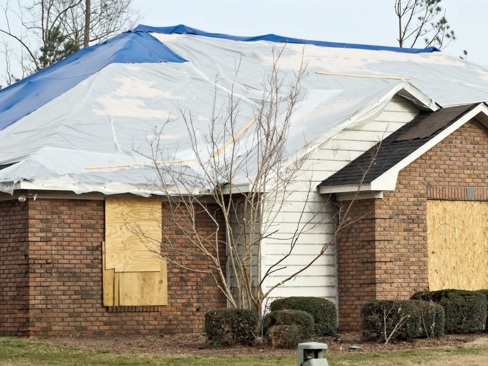 a house with a large tarp over the roof