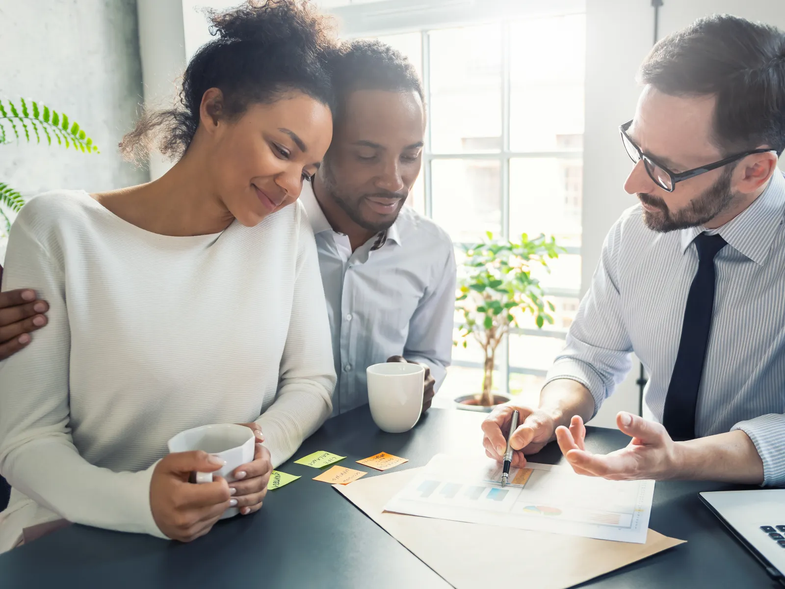 a group of people looking at a paper
