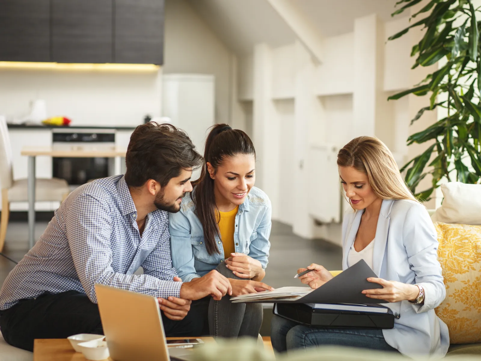 a group of people looking at a laptop