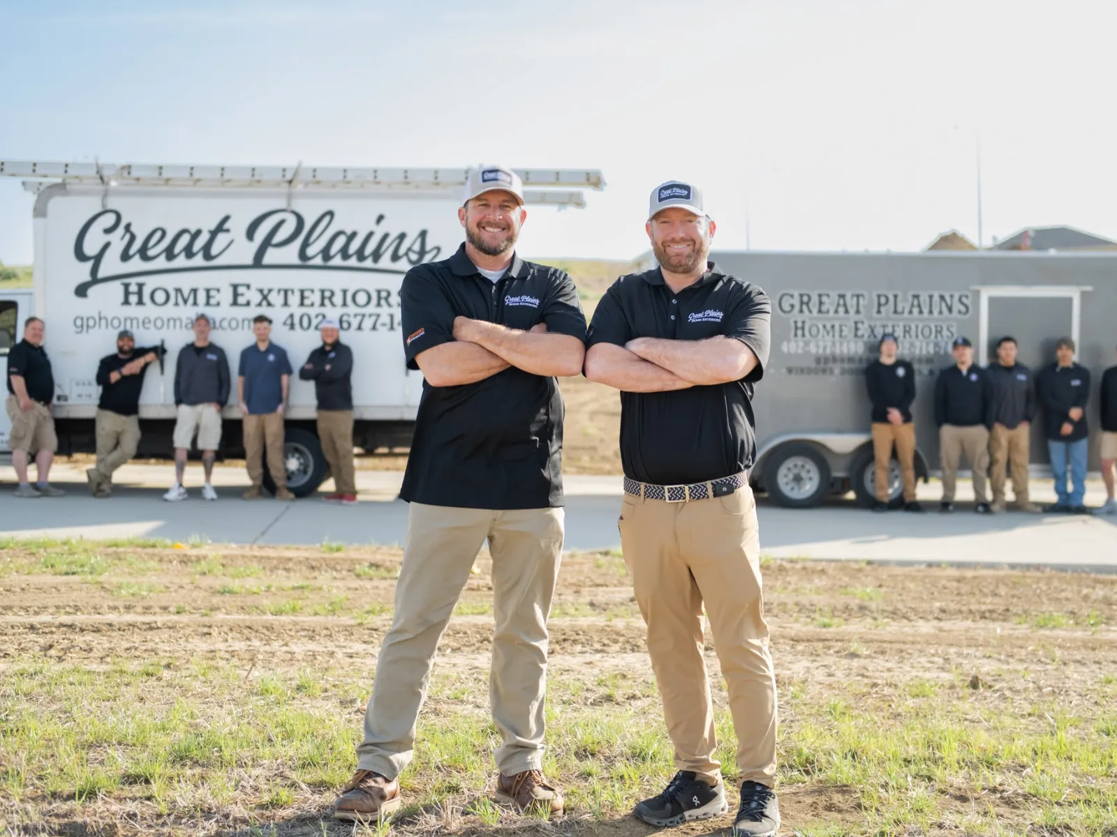Team of professionals from Great Plains Home Exteriors posing in front of their service truck.