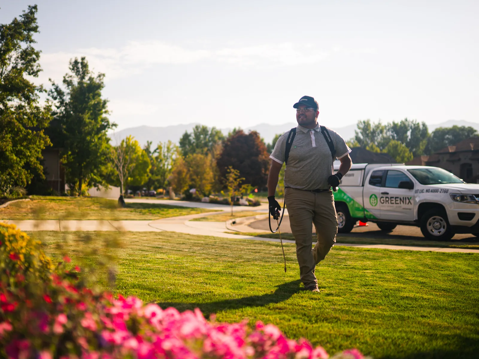 Pest Technician walking to house with tools