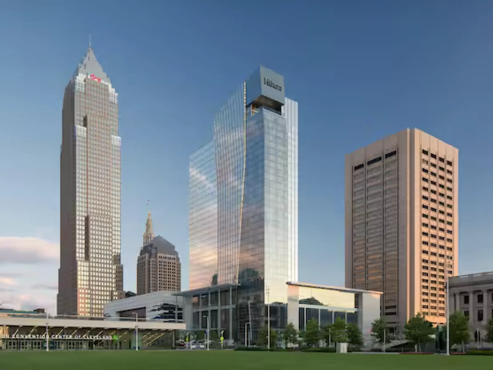 Skyline of Cleveland featuring Key Tower, Hilton hotel, and surrounding skyscrapers under clear blue sky.