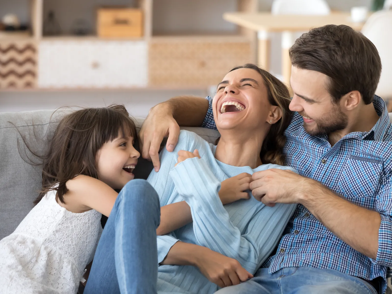 a family sitting on a couch