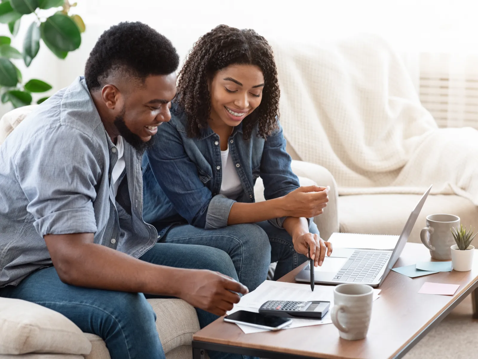 a man and a woman looking at a laptop