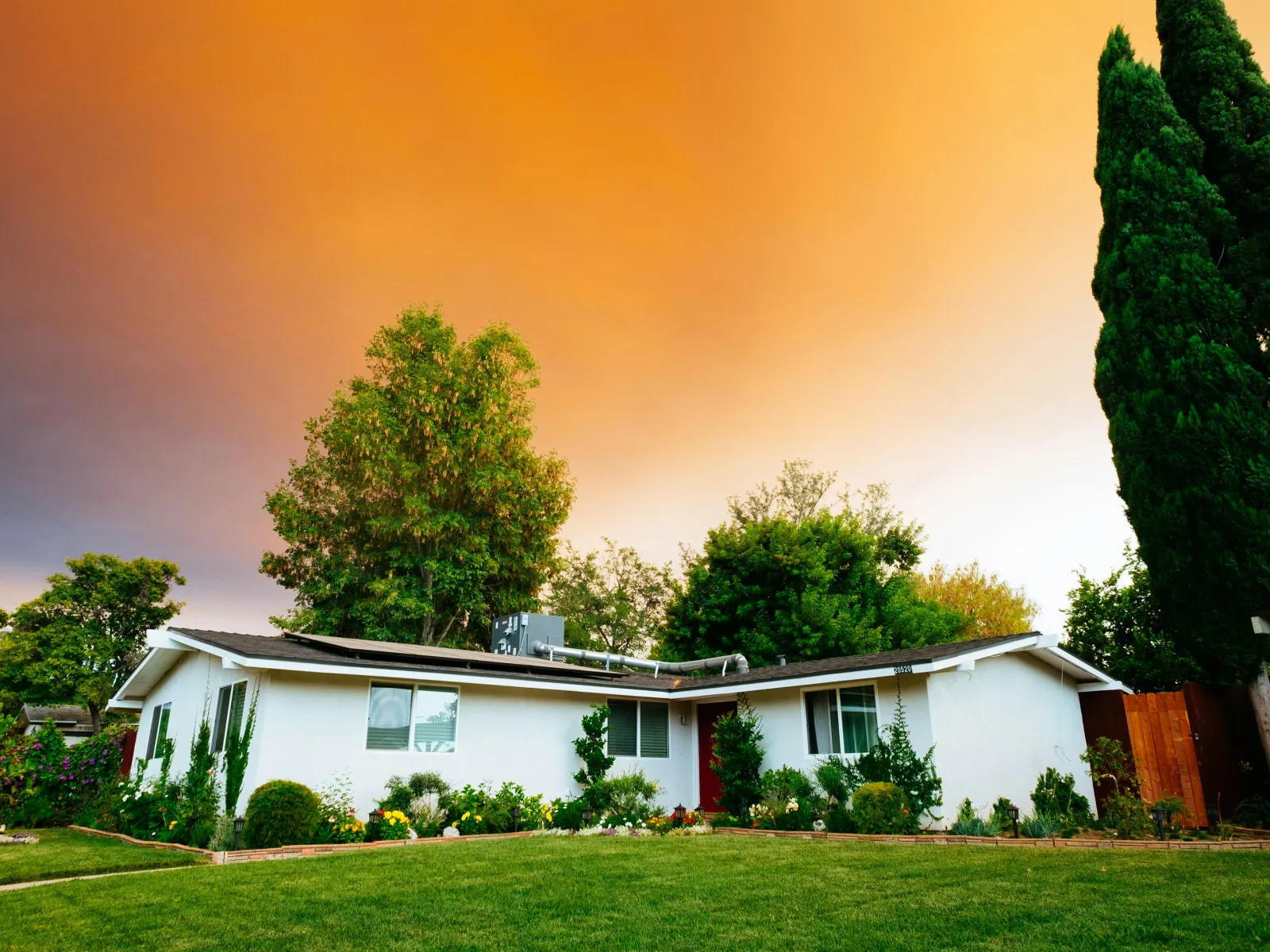 a house with trees and grass in the front