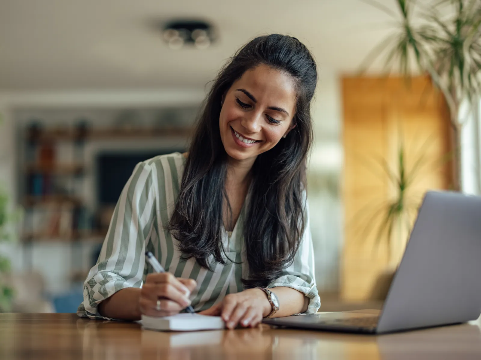 a woman smiling while sitting at a table