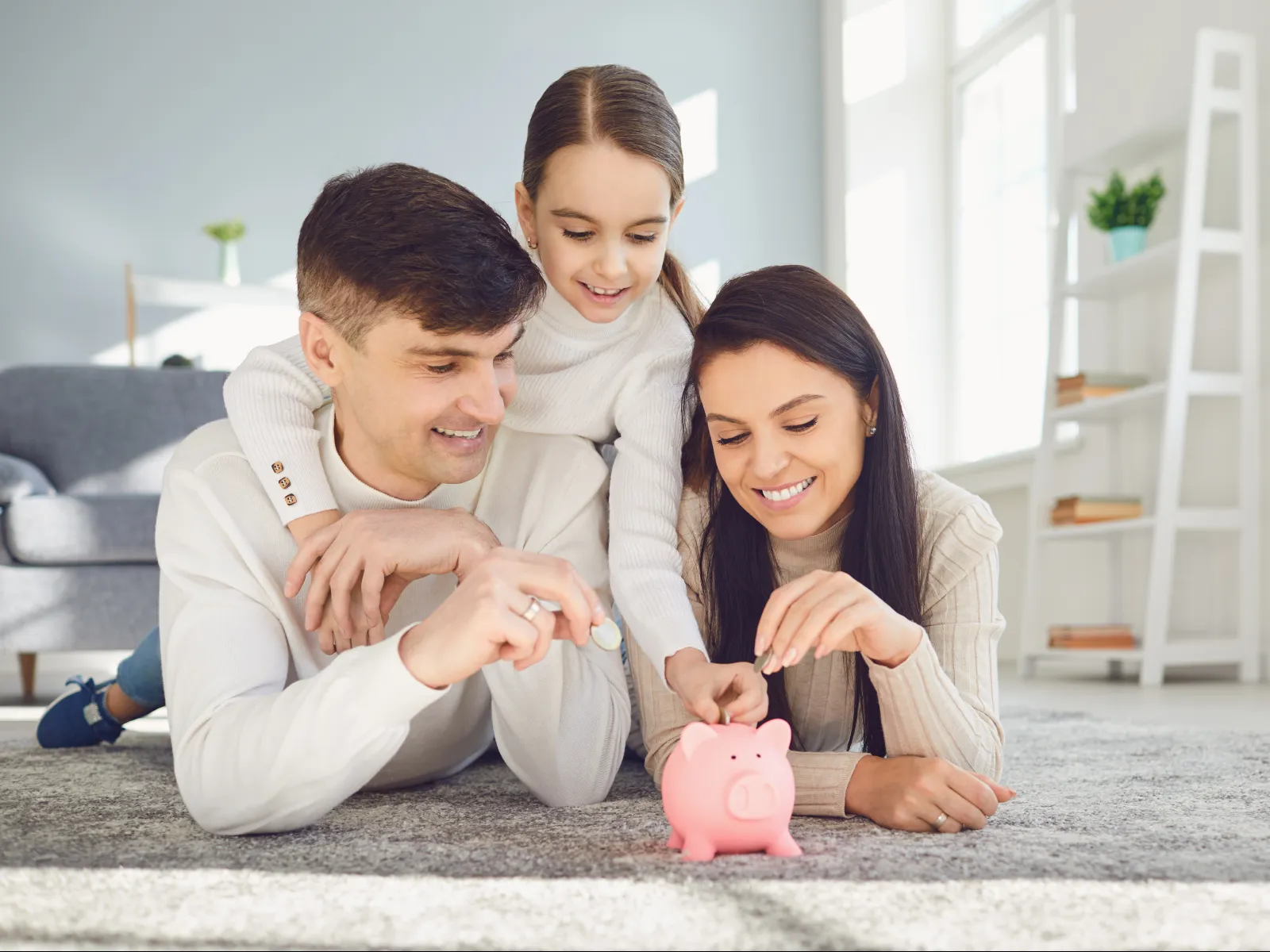 a family playing with a pink ball