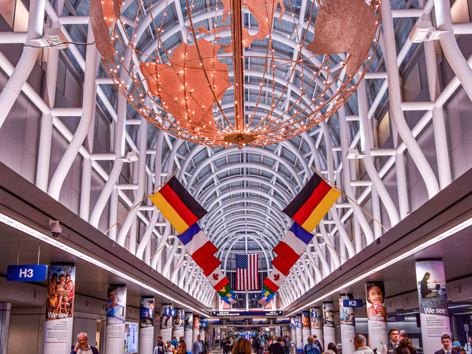 Aerial view of a large multi-level highway interchange surrounded by autumn trees and urban buildings.