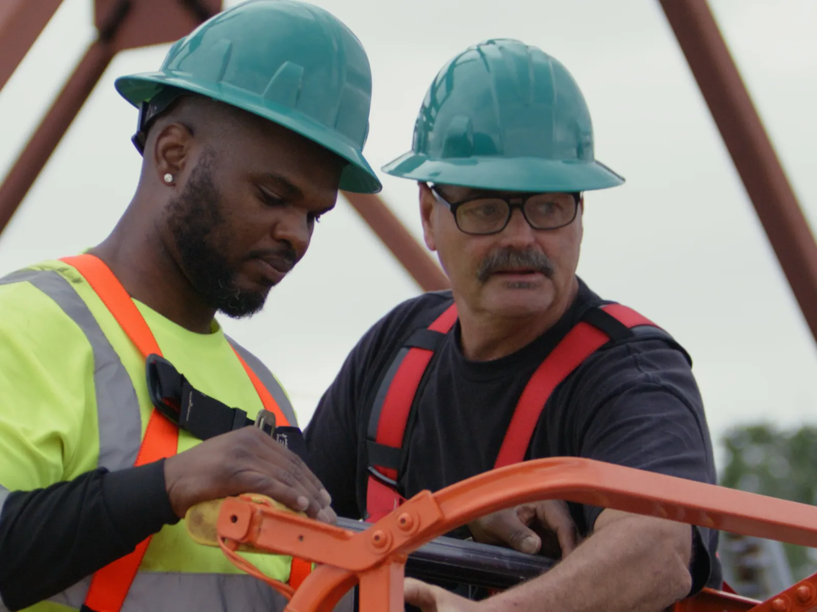 men wearing hard hats and reflectors