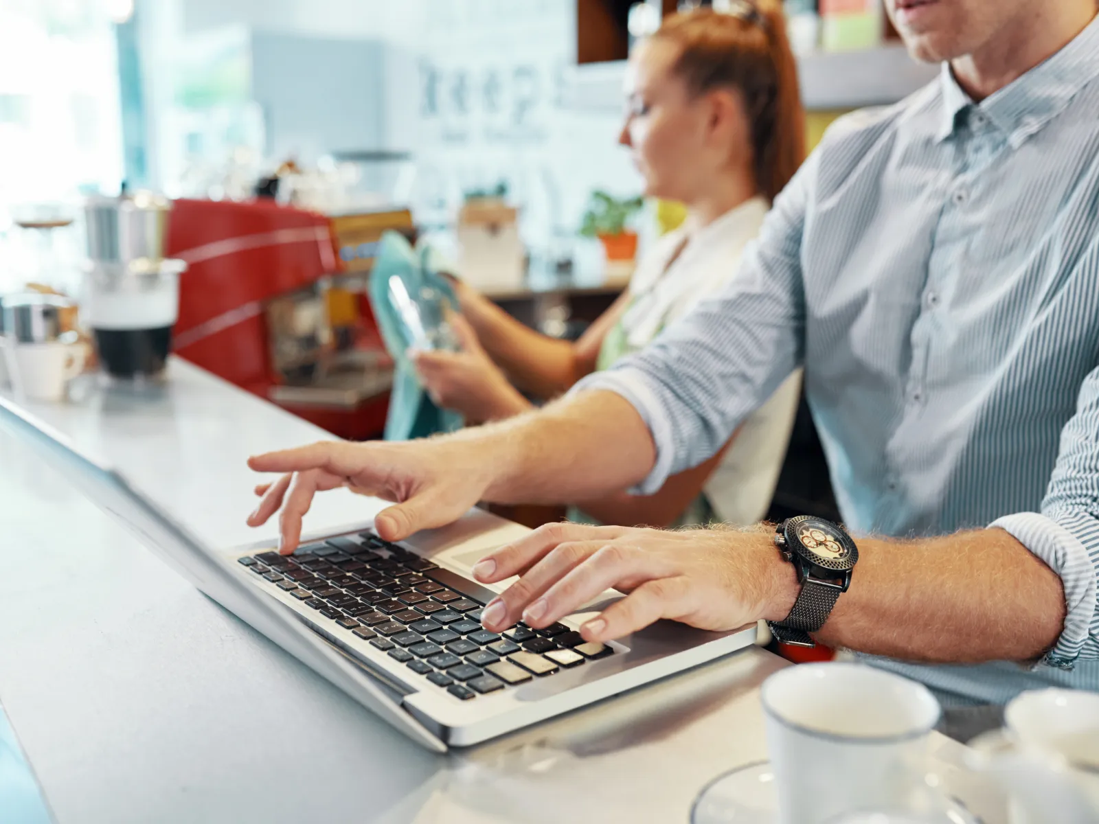 a man and a woman looking at a laptop