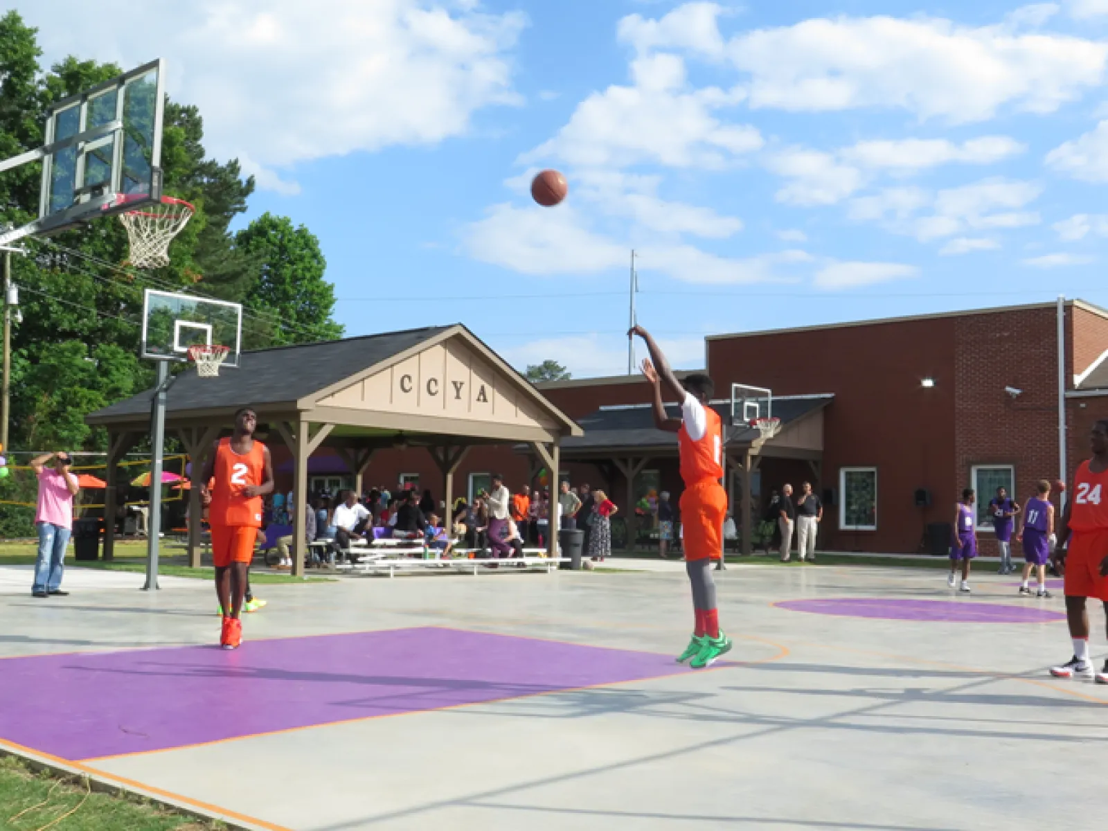 a group of people playing basketball