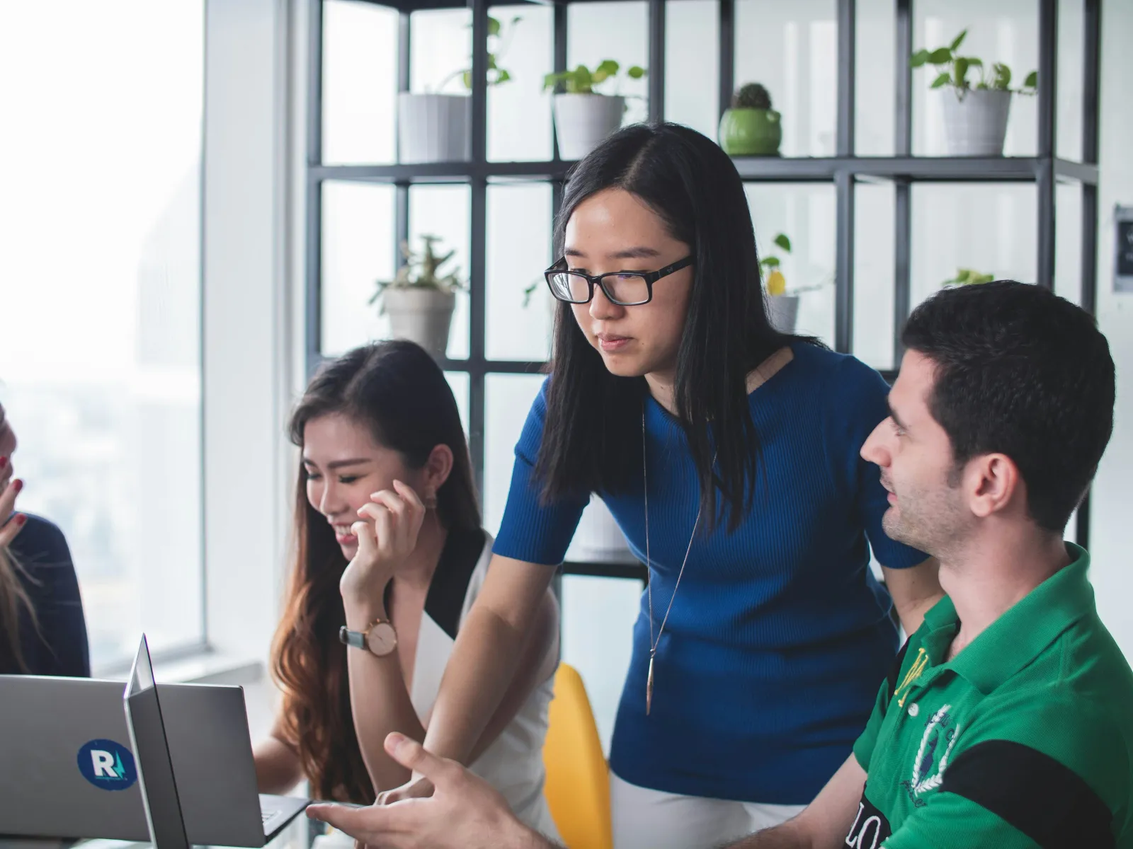 a group of people looking at a computer screen