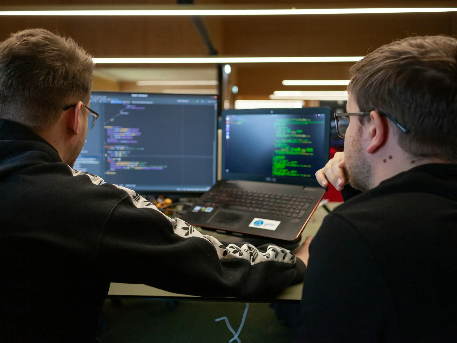 men looking at a laptop