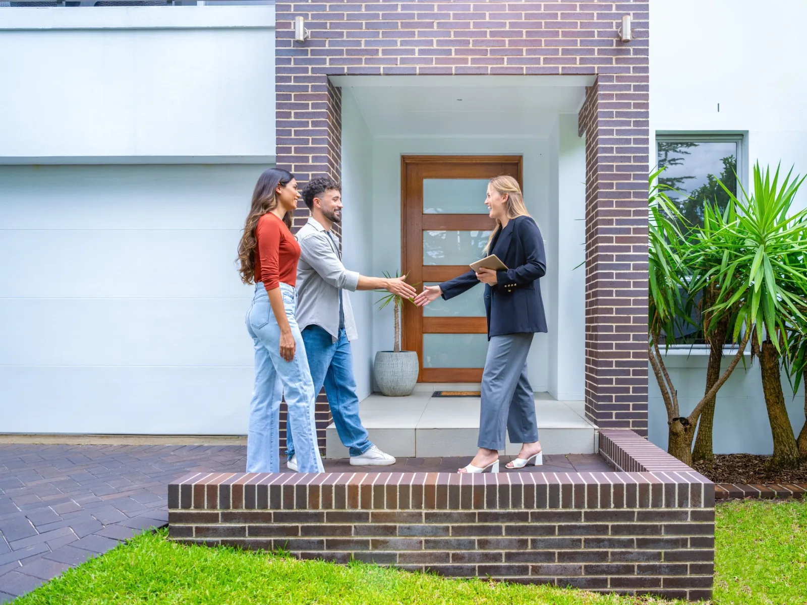 a group of people standing outside a house