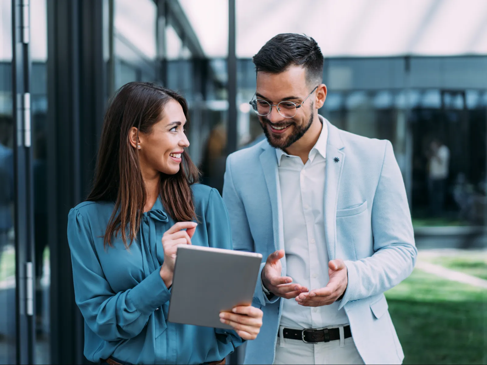a man and a woman looking at a laptop