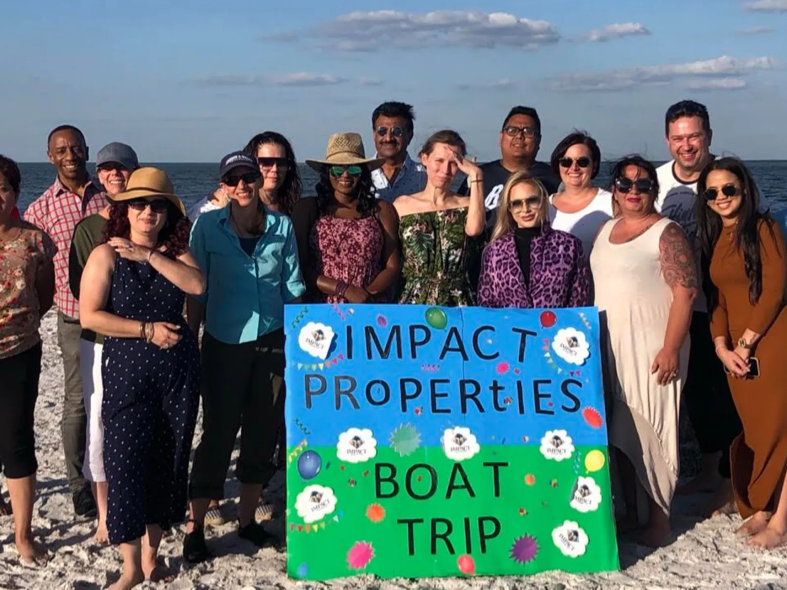 a group of people posing for a photo on a beach