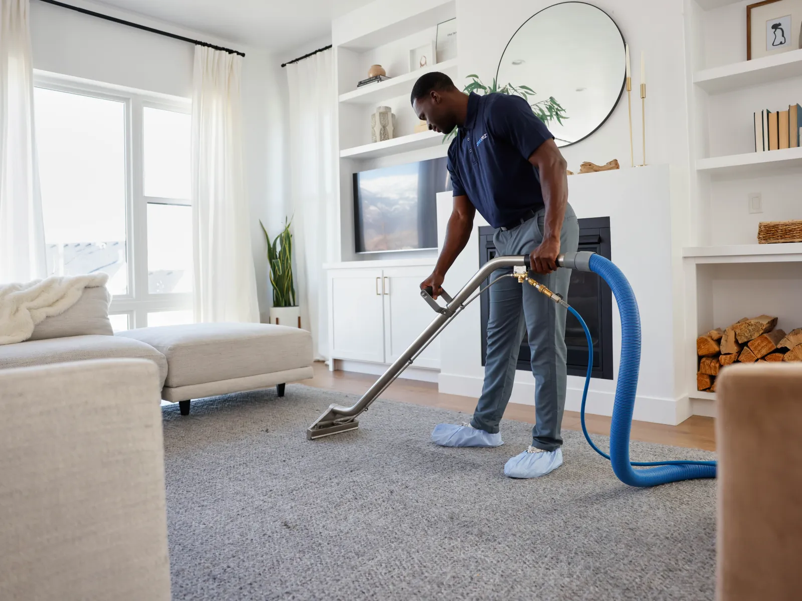 a person vacuuming a living room