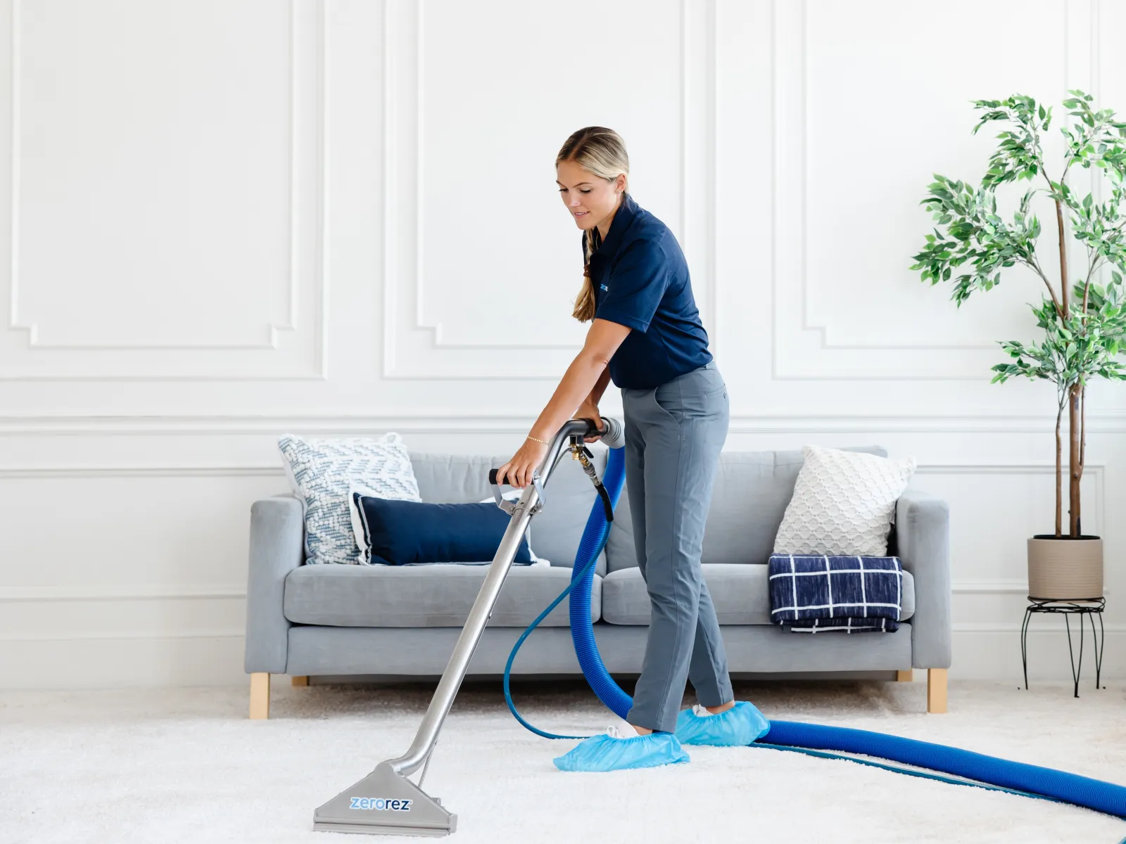 a person vacuuming a living room