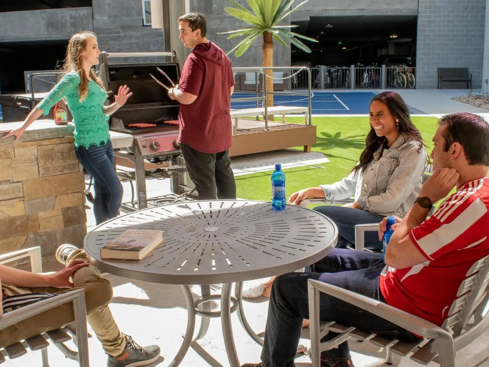 a group of people sitting around a table outside