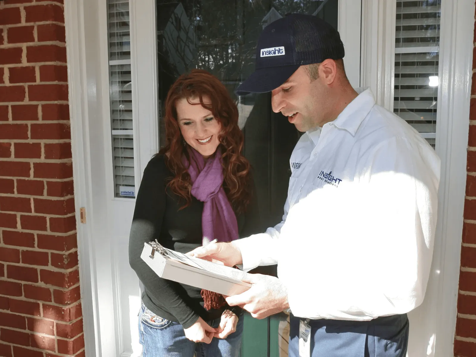 a man and a woman looking at a paper