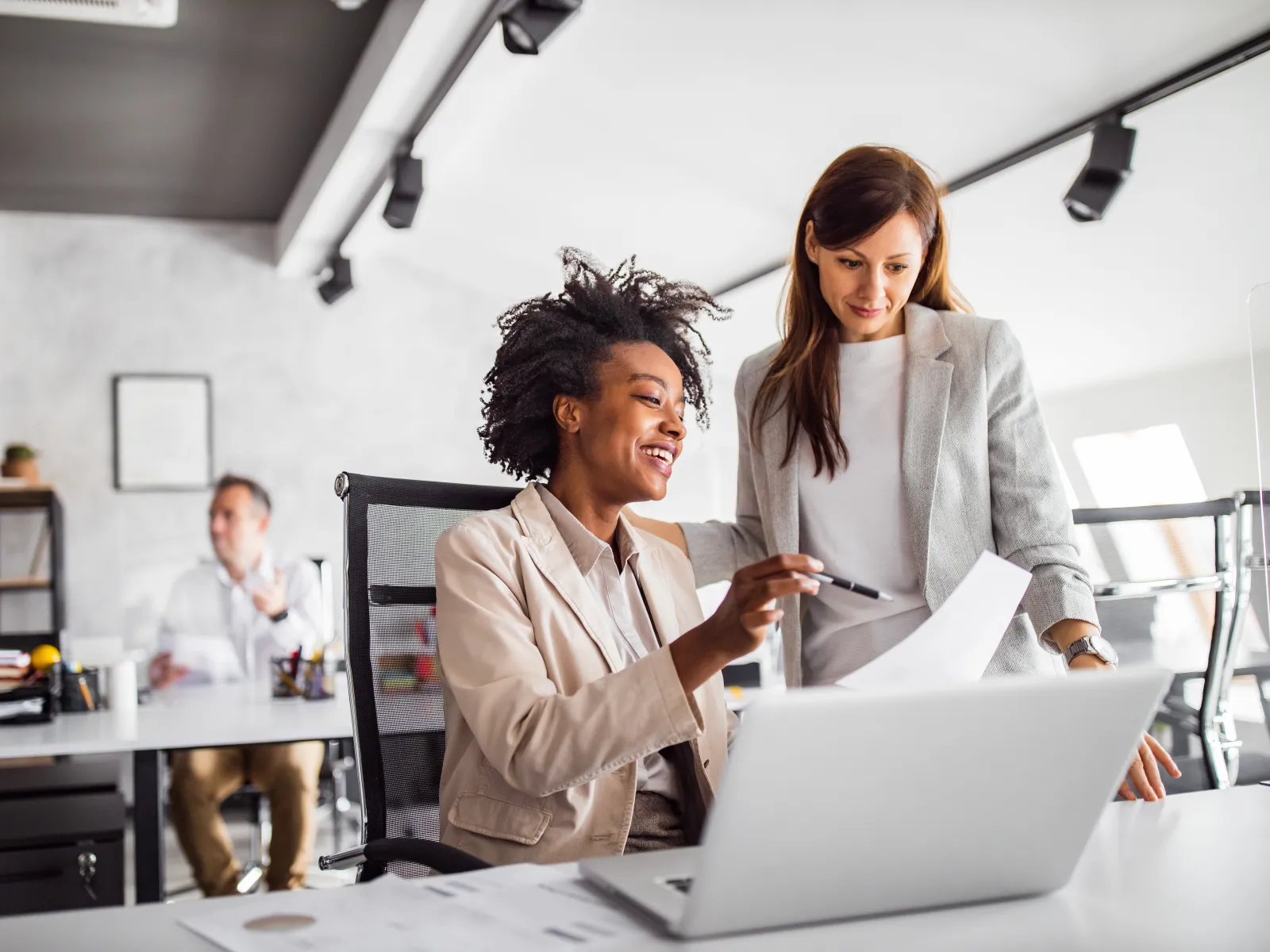 a few business people looking at a laptop