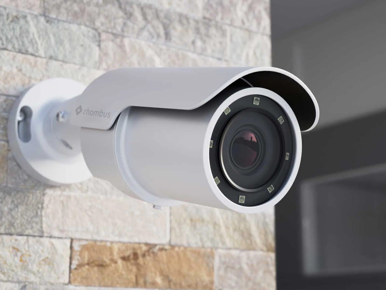a white camera on a brick wall