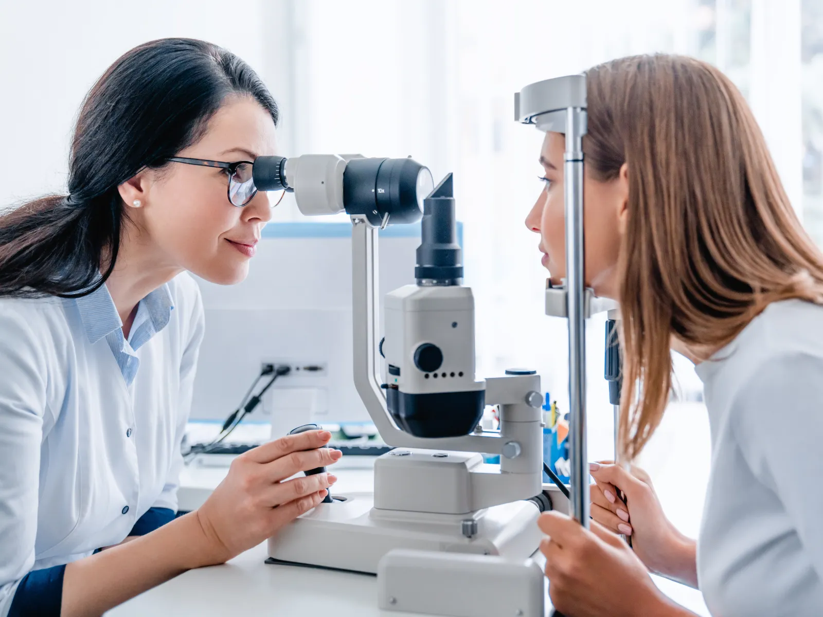 a woman looking at a microscope